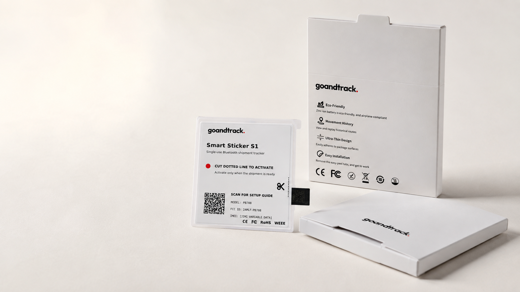 GoAndTrack Smart Sticker S1 retail box standing upright beside a flat-laid box, showing the goandtrack logo and eco-friendly and movement-history feature icons