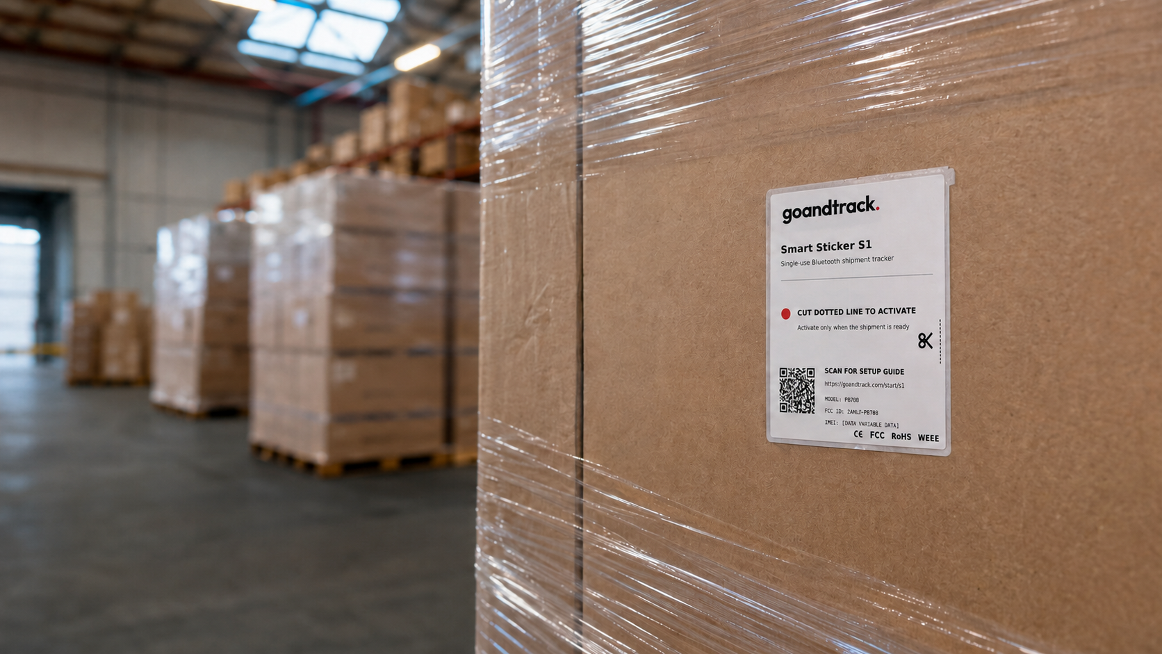 GoAndTrack Smart Sticker S1 applied to a shrink-wrapped pallet in a warehouse loading area
